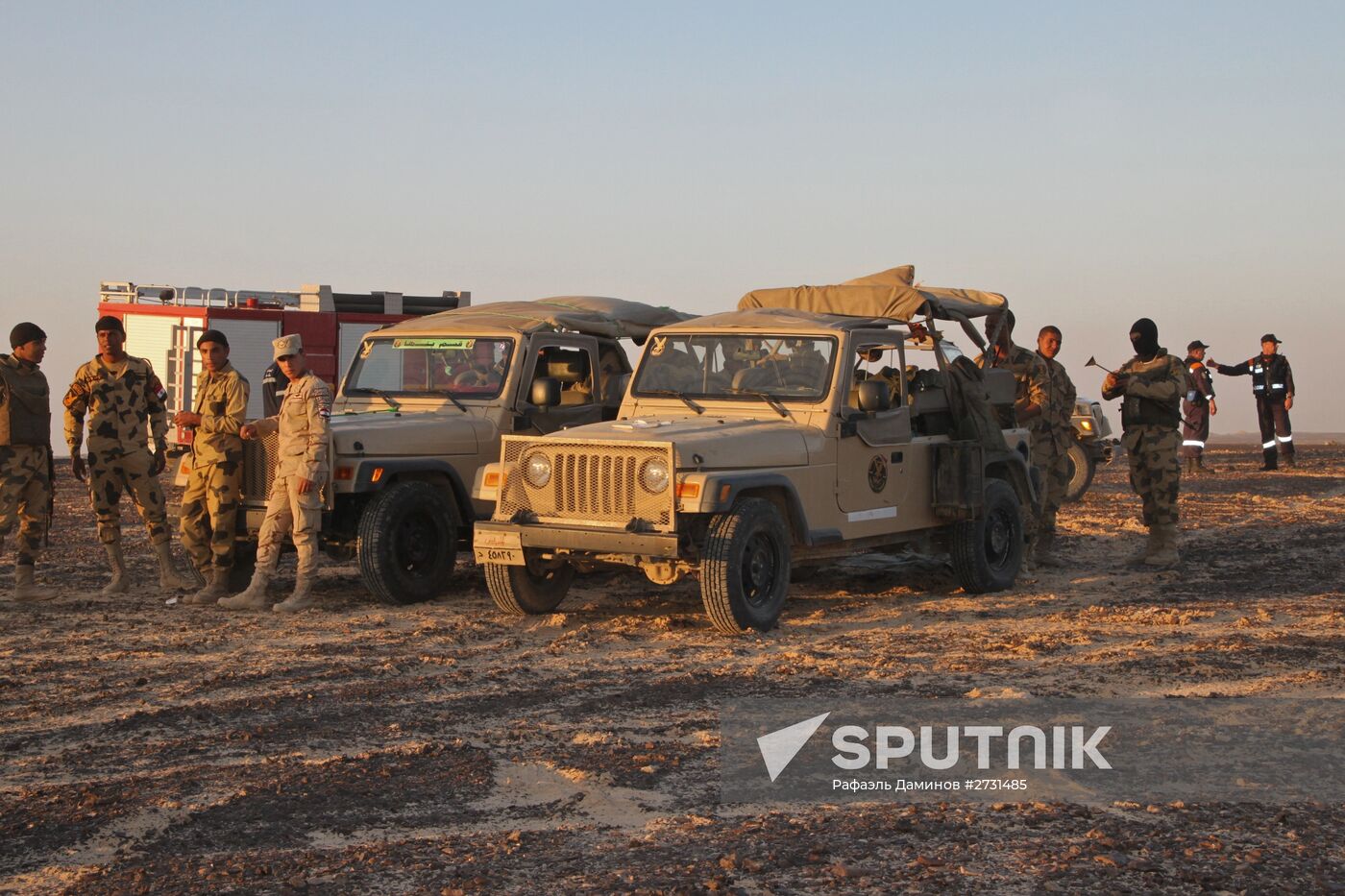 Rescuers search through the crash site of Russian Airbus A321 in Egypt