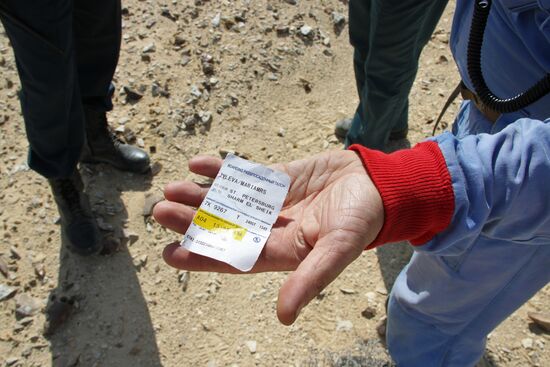 Rescuers search through the crash site of Russian Airbus A321 in Egypt