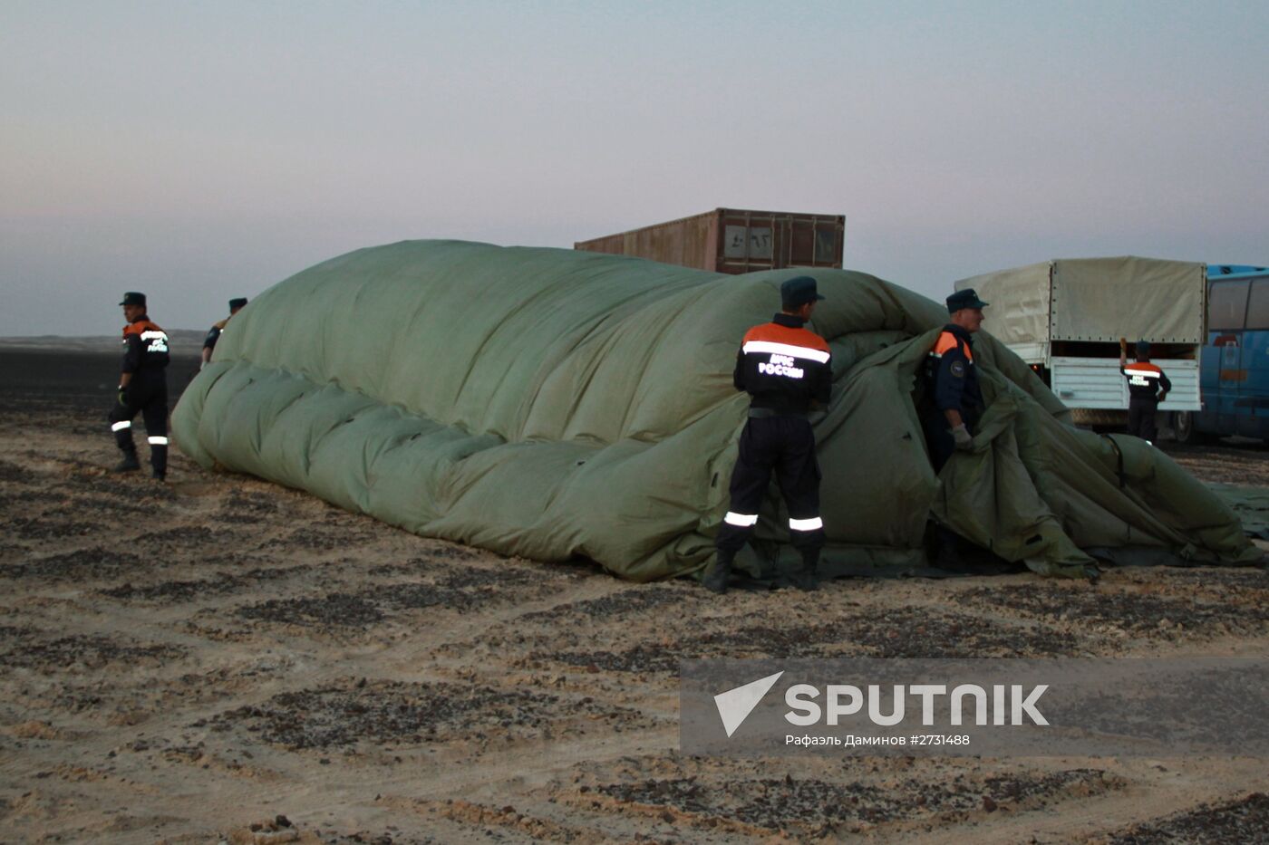 Rescuers search through the crash site of Russian Airbus A321 in Egypt