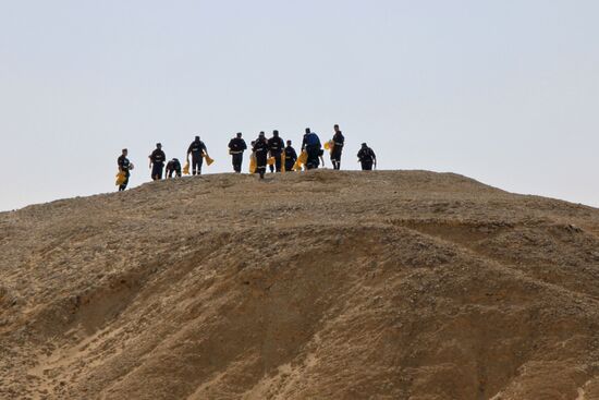 Rescuers search through the crash site of Russian Airbus A321 in Egypt