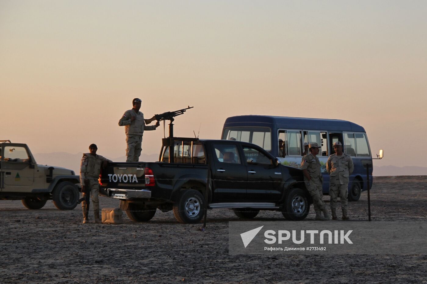 Rescuers search through the crash site of Russian Airbus A321 in Egypt
