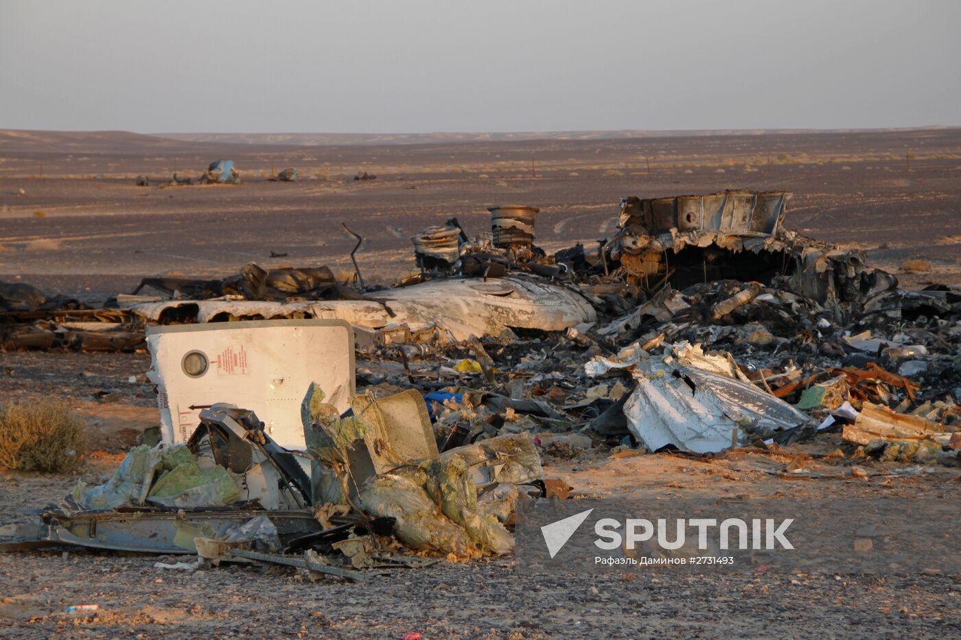 Rescuers search through the crash site of Russian Airbus A321 in Egypt