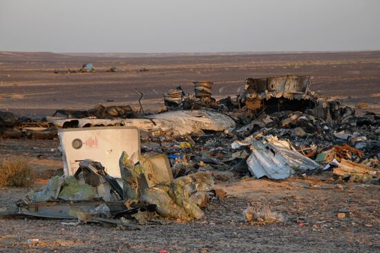 Rescuers search through the crash site of Russian Airbus A321 in Egypt