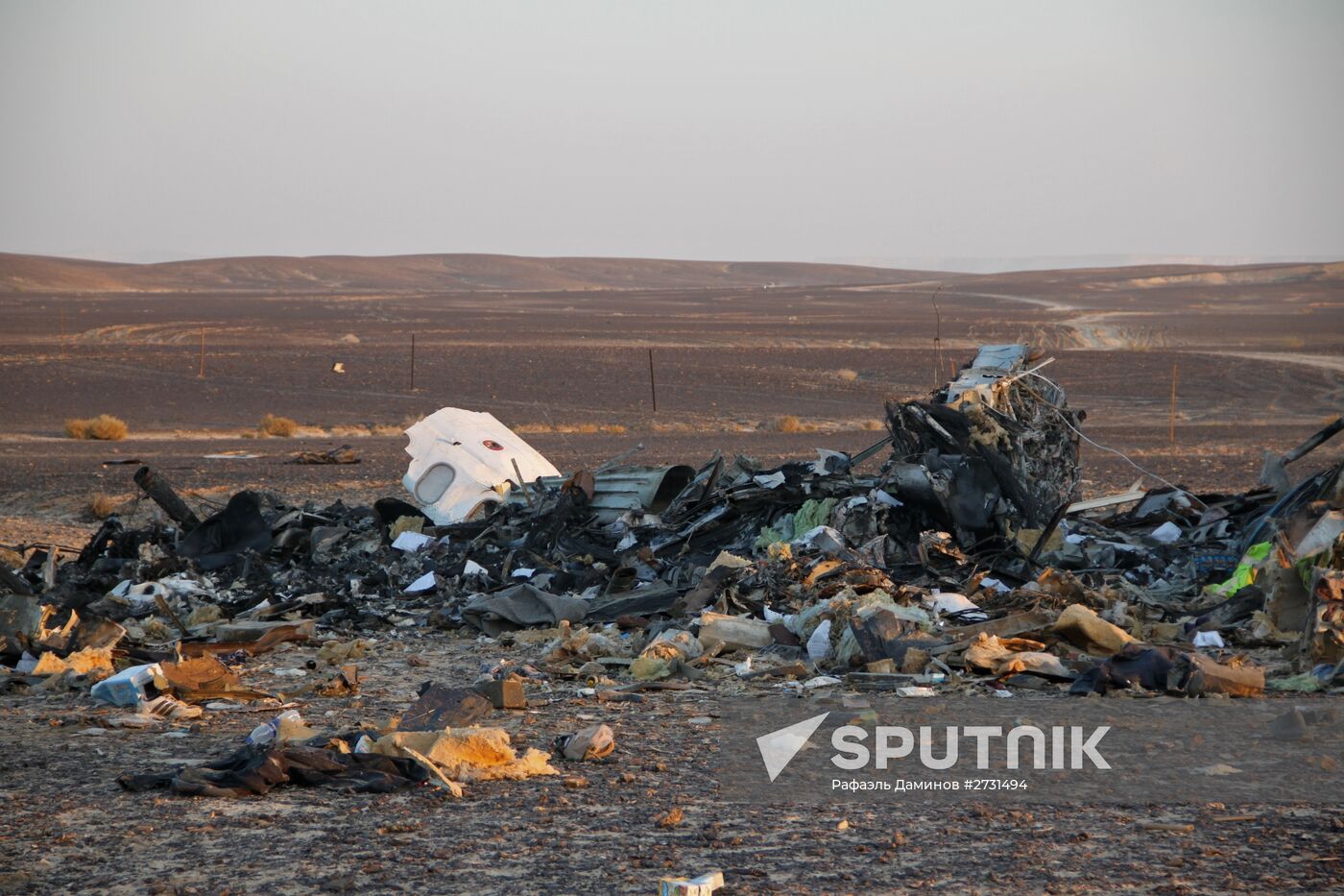 Rescuers search through the crash site of Russian Airbus A321 in Egypt