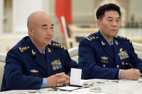 Russian President Vladimir Putin meets with Vice Chairman of China's Central Military Commission Xu Qiliang