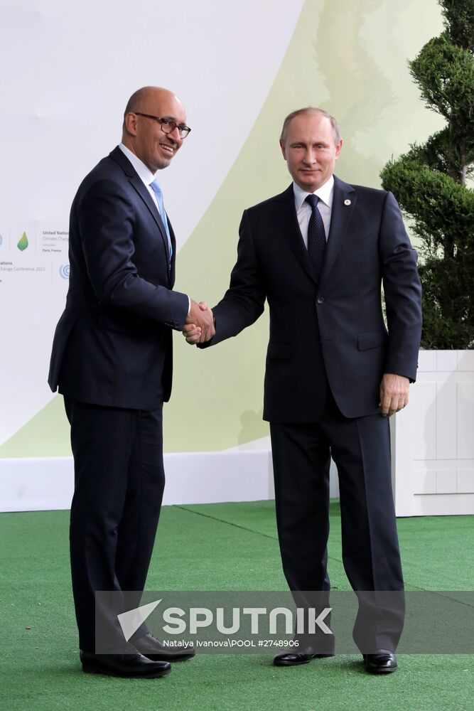 Russian President Vladimir Putin (right) and Harlem Désir, the State Secretary responsible for European Affairs in the French Foreign Ministry, seen on the Le Bourget Exhibition Center premises during the 2015 Paris Climate Conference - United Nations Framework Convention on Climate Change, November 30, 2015. Location: France, Paris. Author: Natalya Ivanova\POOL/Sputnik. President Vladimir Putin visits French Republic