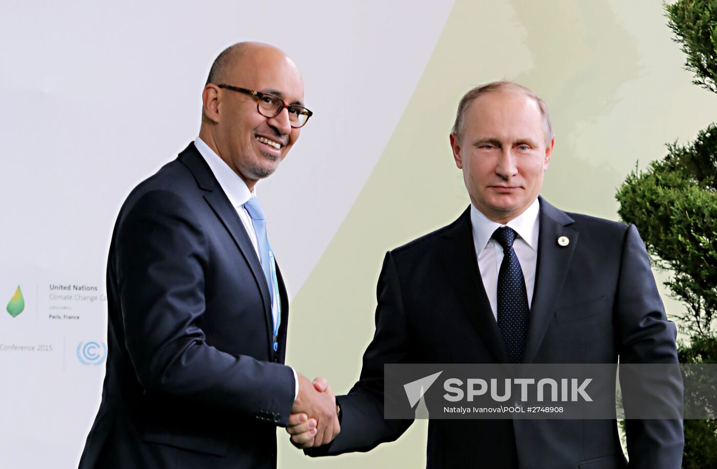 Russian President Vladimir Putin (right) and Harlem Désir, the State Secretary responsible for European Affairs in the French Foreign Ministry, seen on the Le Bourget Exhibition Center premises during the 2015 Paris Climate Conference - United Nations Framework Convention on Climate Change, November 30, 2015. Location: France, Paris. Author: Natalya Ivanova\POOL/Sputnik. President Vladimir Putin visits French Republic