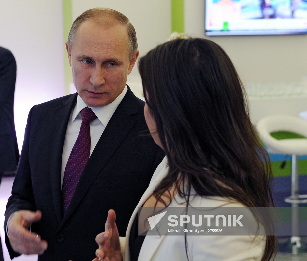 Vladimir Putin visits exhibition marking Russia Today news channel's 10th anniversary