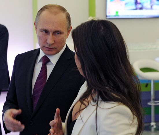 Vladimir Putin visits exhibition marking Russia Today news channel's 10th anniversary