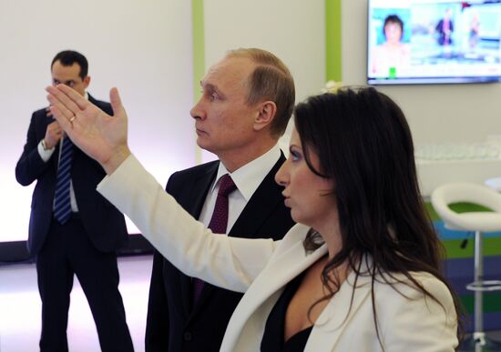 Vladimir Putin visits exhibition marking Russia Today news channel's 10th anniversary