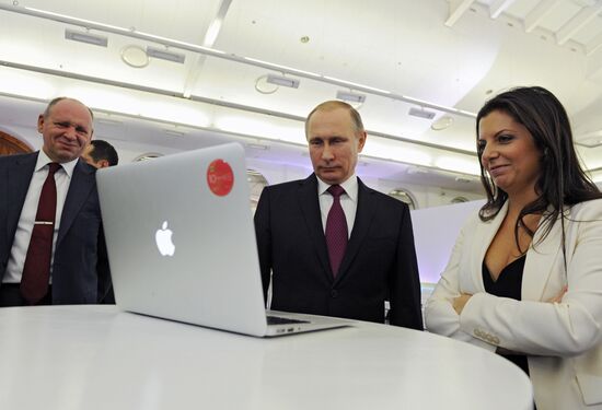 Vladimir Putin visits exhibition marking Russia Today news channel's 10th anniversary