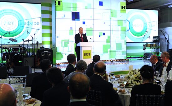 Vladimir Putin visits exhibition marking Russia Today news channel's 10th anniversary