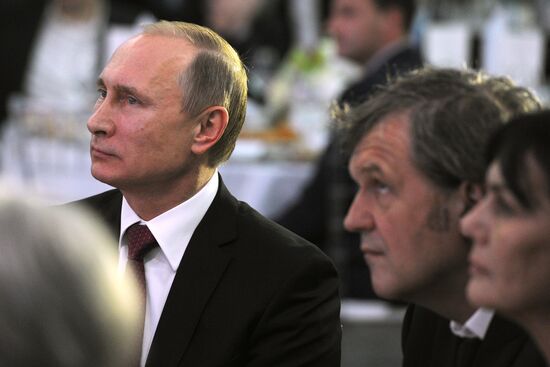 Vladimir Putin visits exhibition marking Russia Today news channel's 10th anniversary