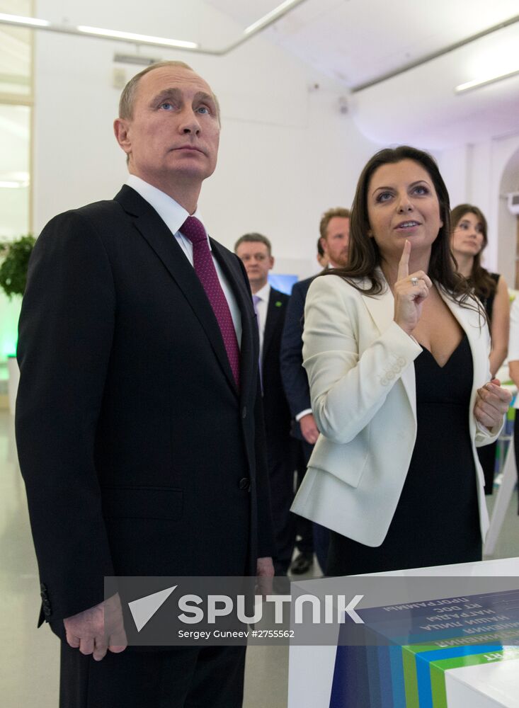 Vladimir Putin visits exhibition marking Russia Today news channel's 10th anniversary