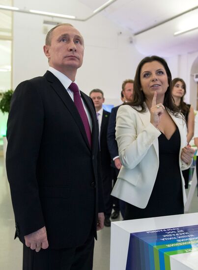 Vladimir Putin visits exhibition marking Russia Today news channel's 10th anniversary