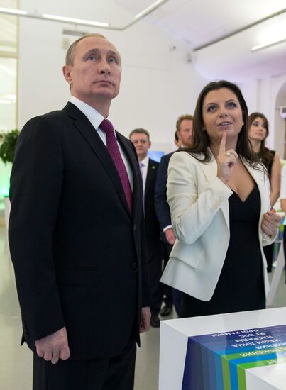 Vladimir Putin visits exhibition marking Russia Today news channel's 10th anniversary