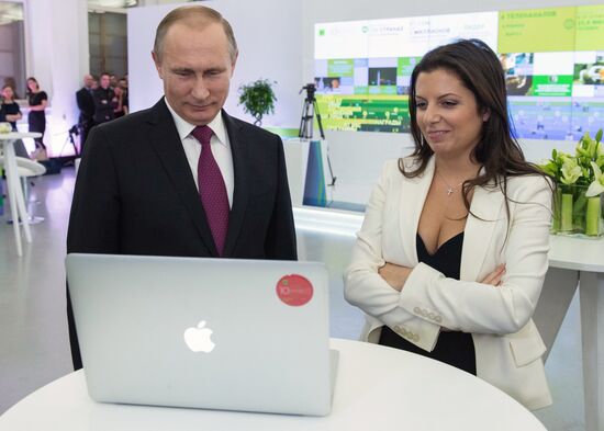 Vladimir Putin visits exhibition marking Russia Today news channel's 10th anniversary