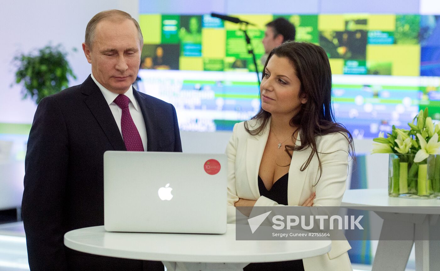 Vladimir Putin visits exhibition marking Russia Today news channel's 10th anniversary