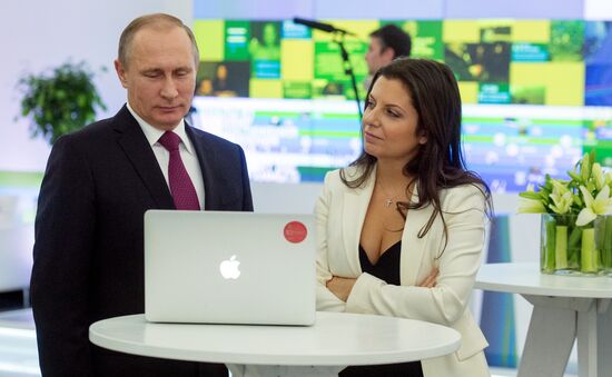 Vladimir Putin visits exhibition marking Russia Today news channel's 10th anniversary
