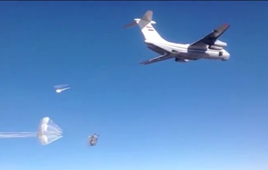 Dropping humanitarian cargo on parachute platforms in Deir ez-Zor