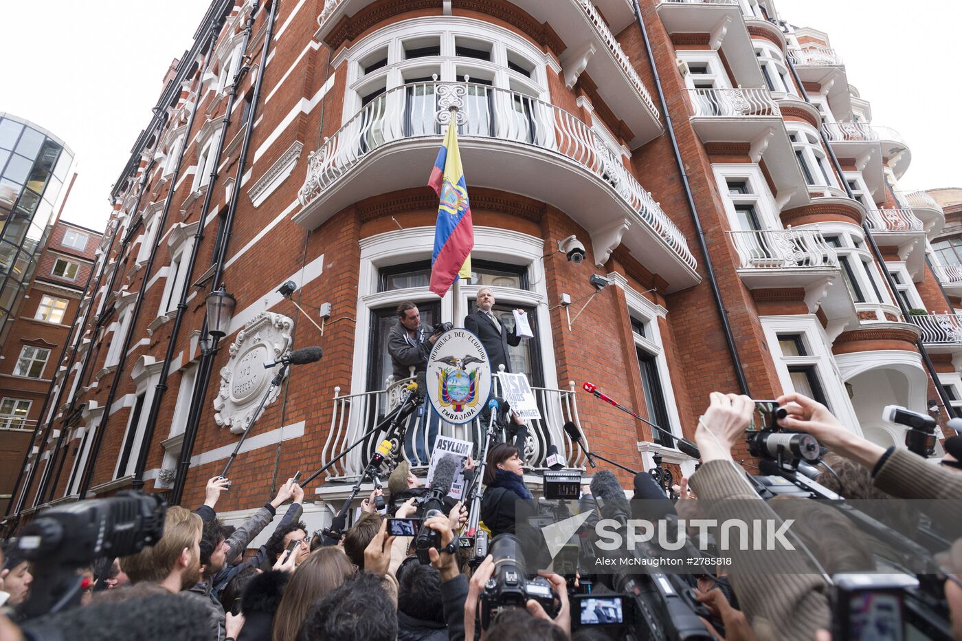 Julian Assange addresses journalists and protesters from Ecuadoran Embassy in London