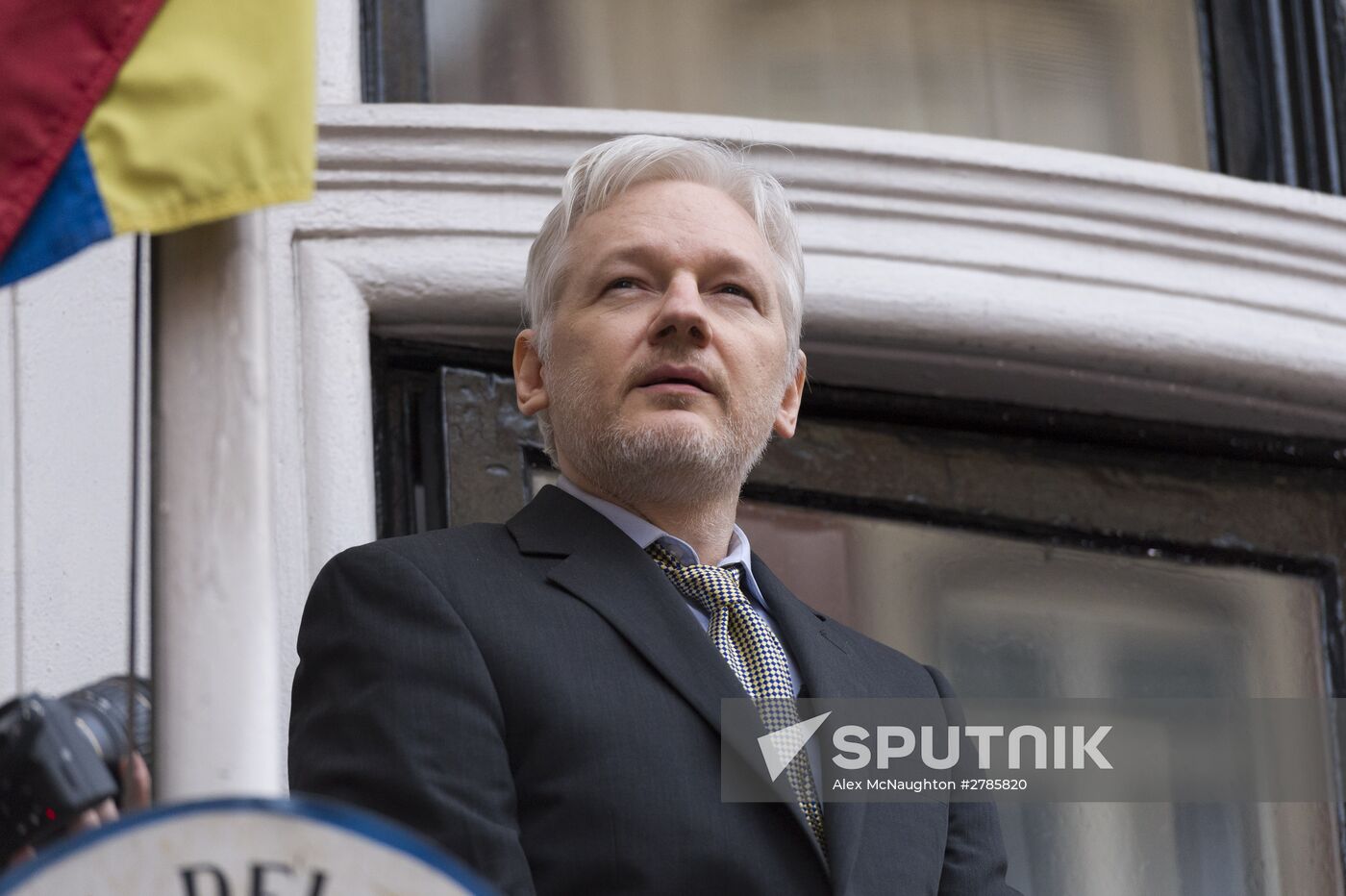 Julian Assange addresses journalists and protesters from Ecuadoran Embassy in London