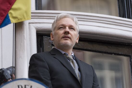 Julian Assange addresses journalists and protesters from Ecuadoran Embassy in London