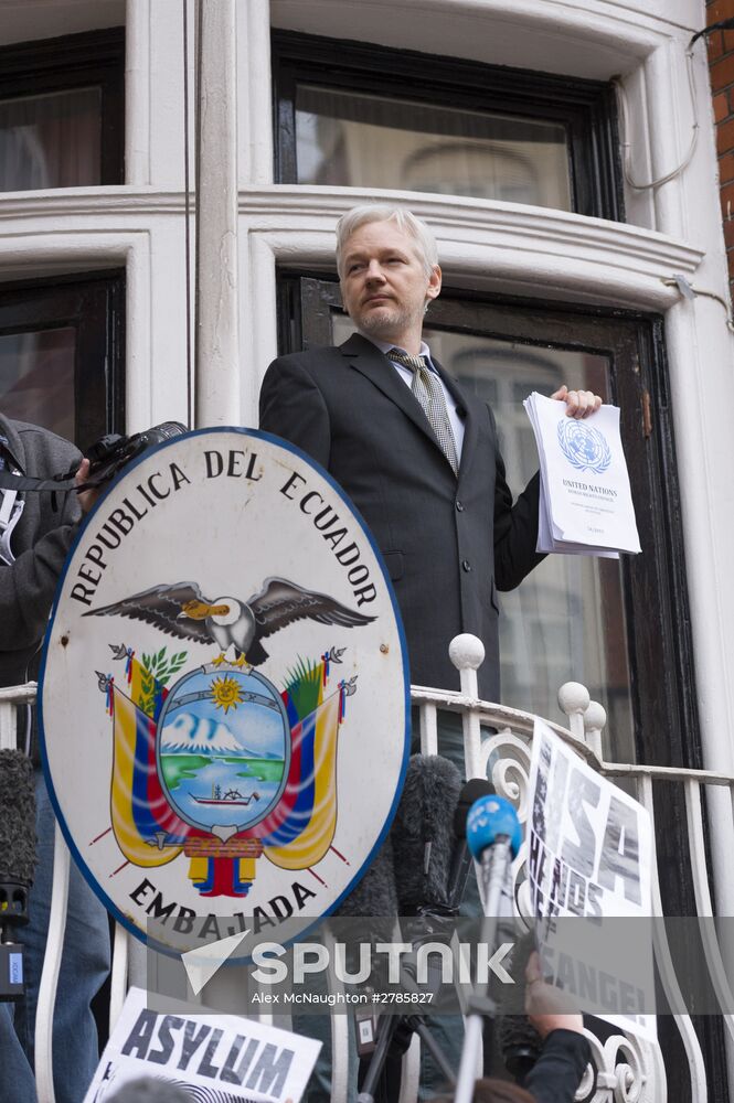Julian Assange addresses journalists and protesters from Ecuadoran Embassy in London
