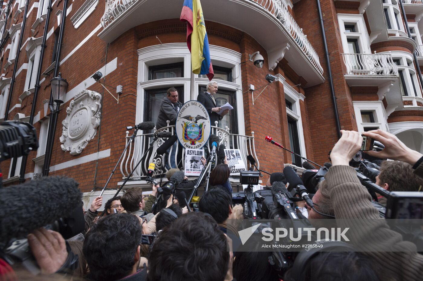 Julian Assange addresses journalists and protesters from Ecuadoran Embassy in London