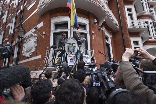 Julian Assange addresses journalists and protesters from Ecuadoran Embassy in London