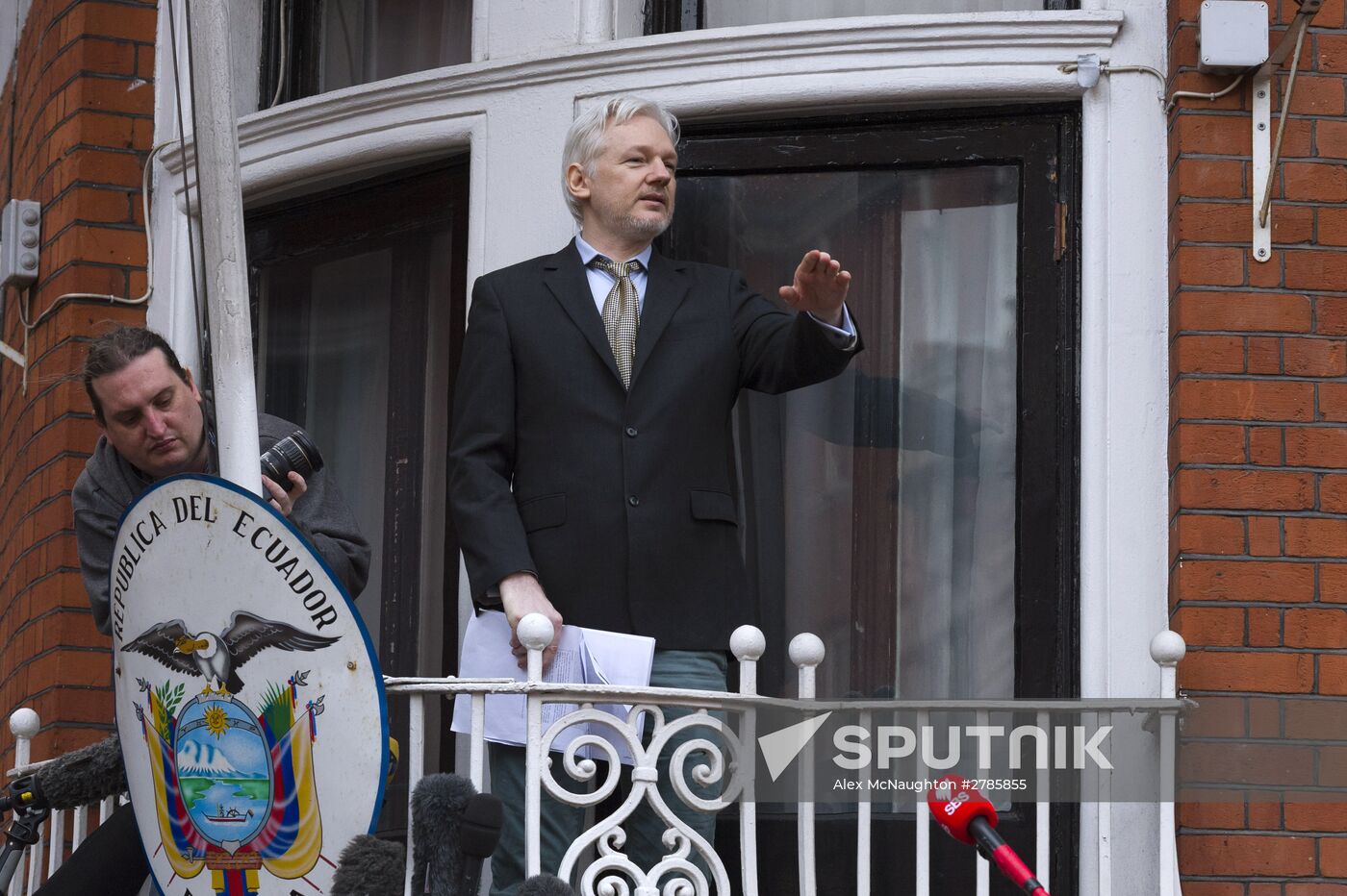 Julian Assange addresses journalists and protesters from Ecuadoran Embassy in London