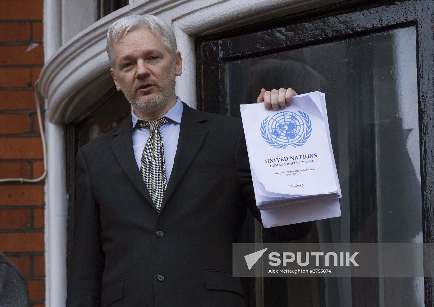Julian Assange addresses journalists and protesters from Ecuadoran Embassy in London