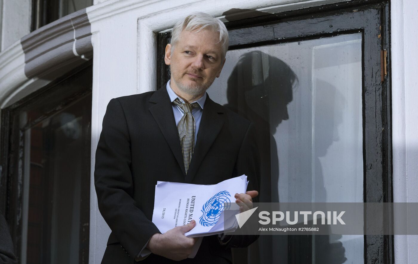 Julian Assange addresses journalists and protesters from Ecuadoran Embassy in London