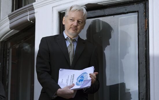 Julian Assange addresses journalists and protesters from Ecuadoran Embassy in London