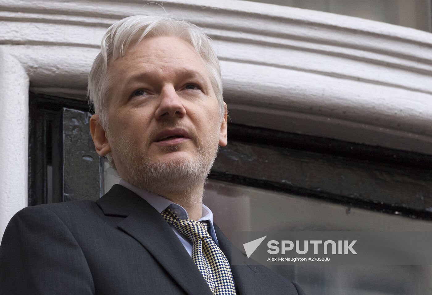 Julian Assange addresses journalists and protesters from Ecuadoran Embassy in London