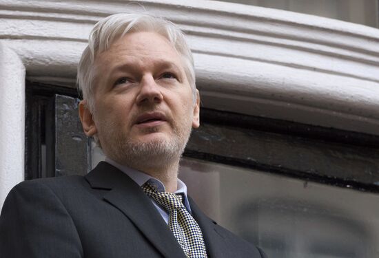 Julian Assange addresses journalists and protesters from Ecuadoran Embassy in London