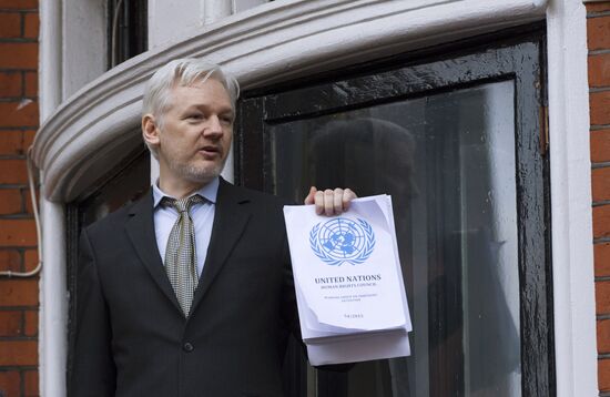 Julian Assange addresses journalists and protesters from Ecuadoran Embassy in London