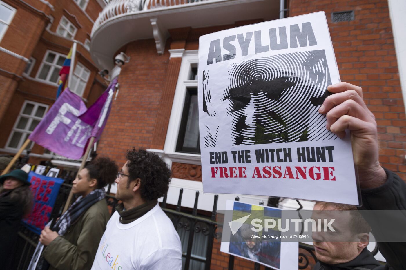 Julian Assange addresses journalists and protesters from Ecuadoran Embassy in London