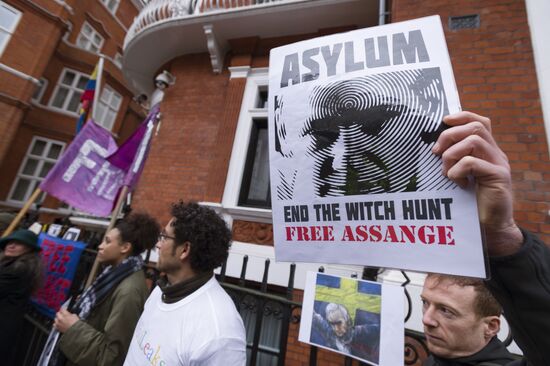 Julian Assange addresses journalists and protesters from Ecuadoran Embassy in London