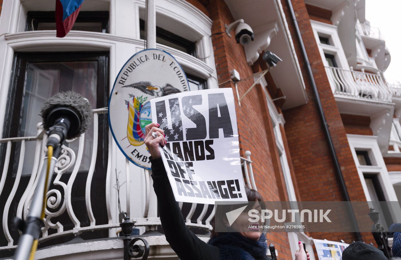 Julian Assange addresses journalists and protesters from Ecuadoran Embassy in London