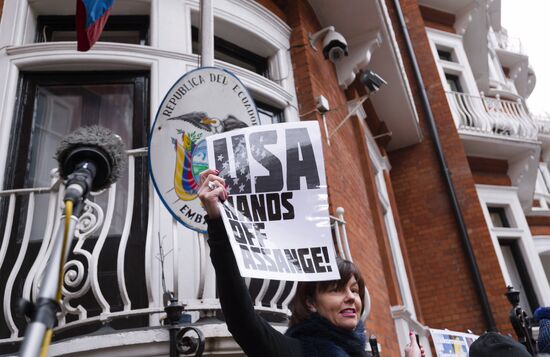 Julian Assange addresses journalists and protesters from Ecuadoran Embassy in London