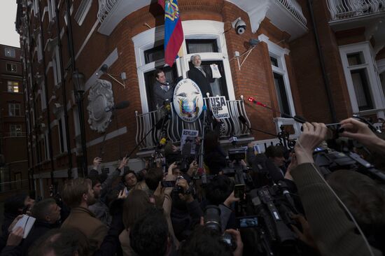 Julian Assange addresses journalists and protesters from Ecuadoran Embassy in London