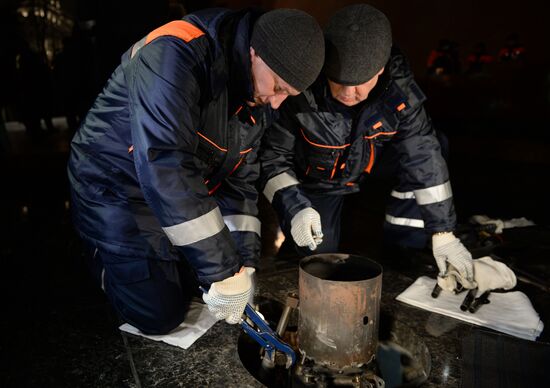Checking burner of Eternal Flame before Defender of Fatherland Day