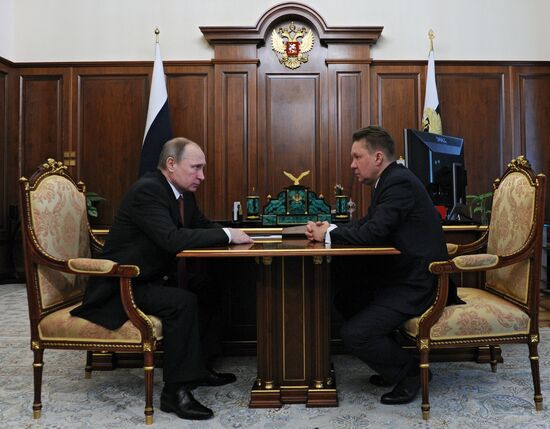 Russian President Vladimir Putin meets with Gazprom head Alexei Miller