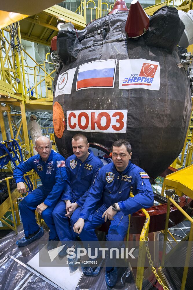 ISS 47/48 prime crew try on space suits, inspect spacecraft