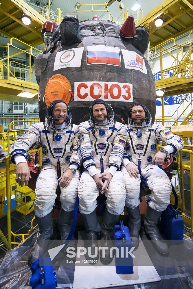ISS 47/48 prime crew try on space suits, inspect spacecraft