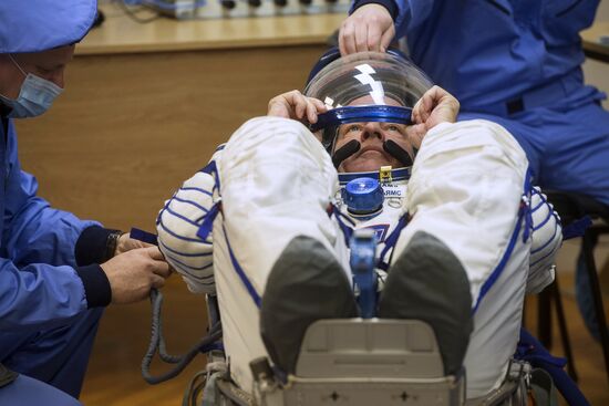 ISS 47/48 prime crew try on space suits, inspect spacecraft
