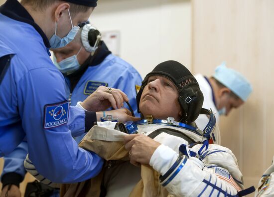 ISS 47/48 prime crew try on space suits, inspect spacecraft