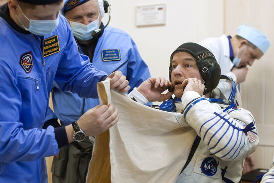 ISS 47/48 prime crew try on space suits, inspect spacecraft