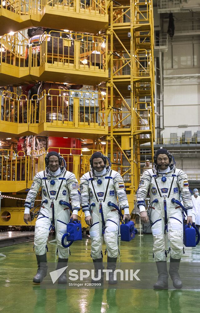 ISS 47/48 prime crew try on space suits, inspect spacecraft